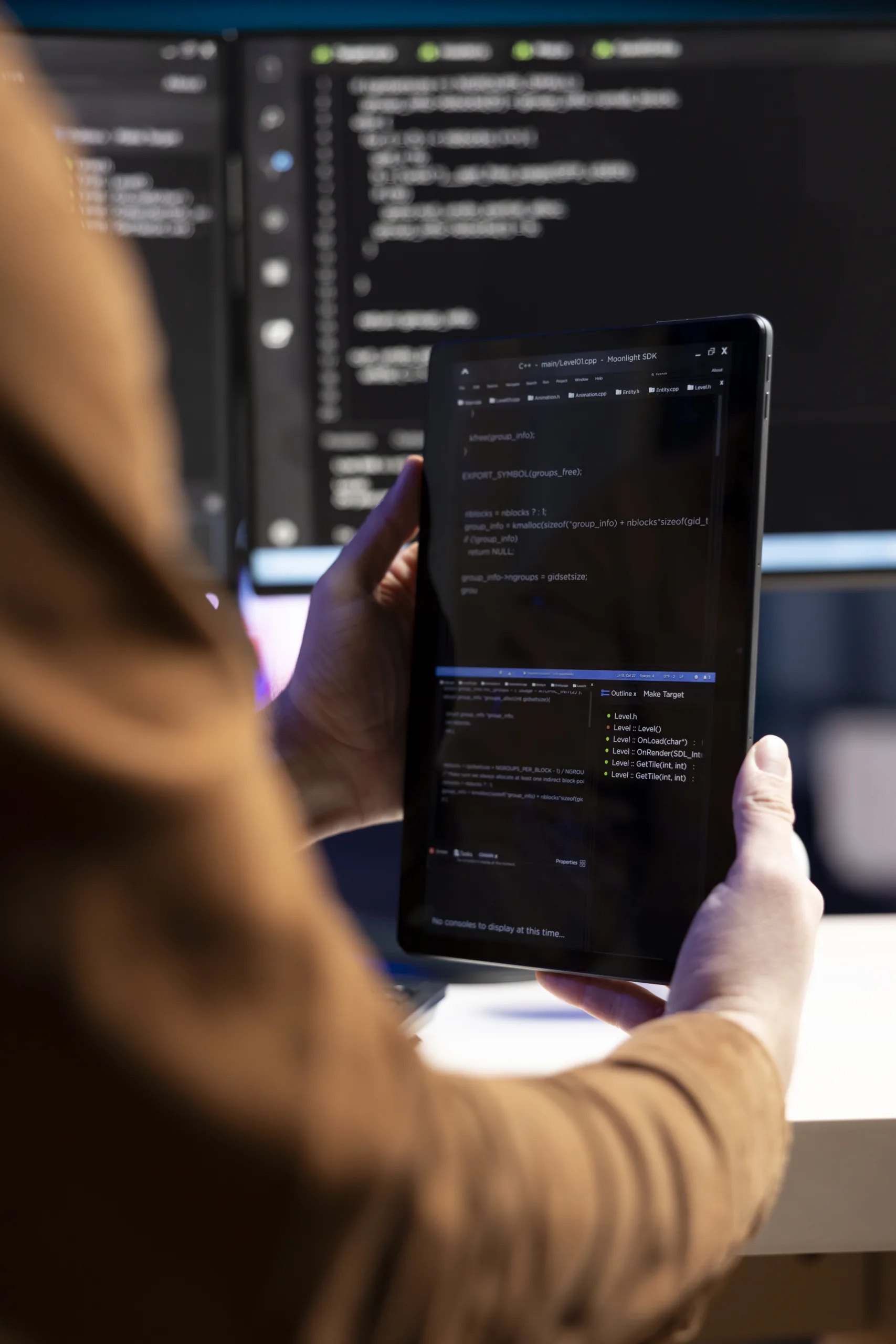 Teleworking programmer designing and developing software applications using tablet. IT administrator implementing and maintaining company systems using portable device, close up